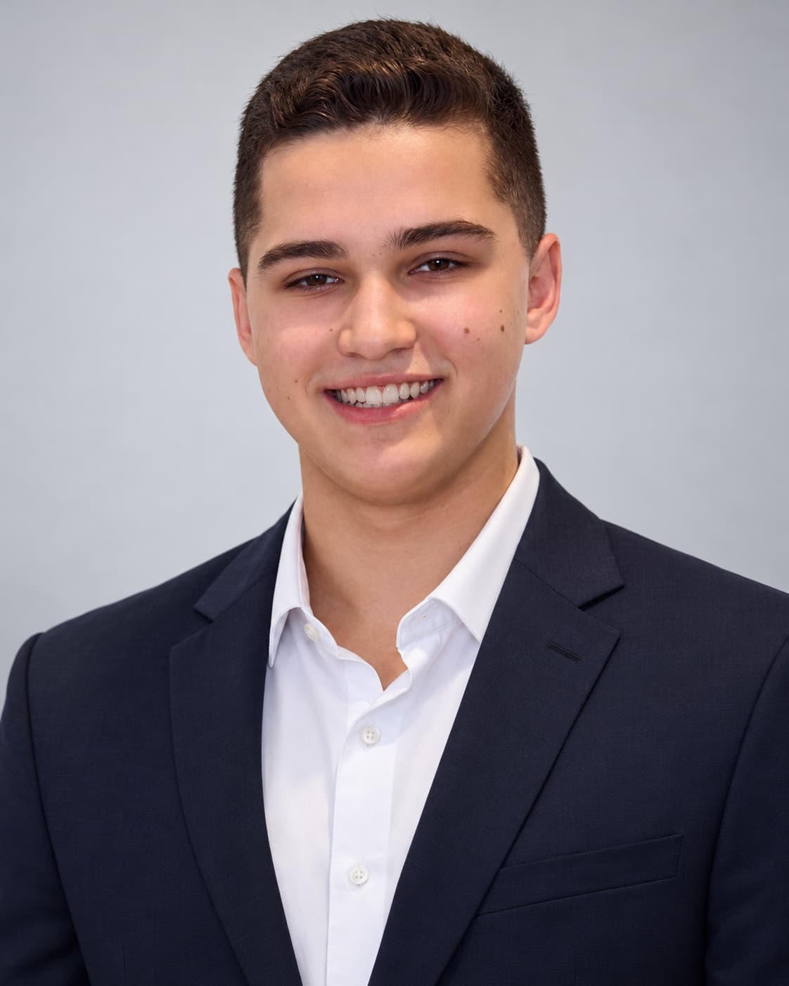 Aaron Prager, headshot in a navy blazer and white shirt